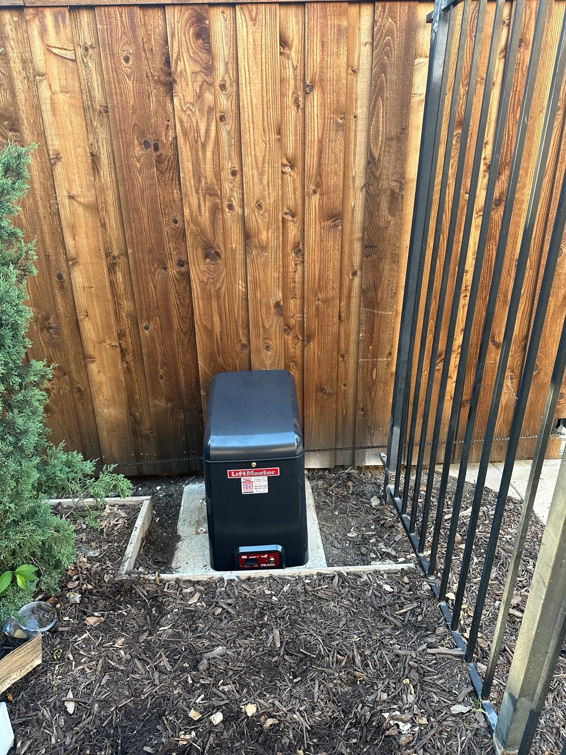 LiftMaster sliding gate operator installed beside residential gate
