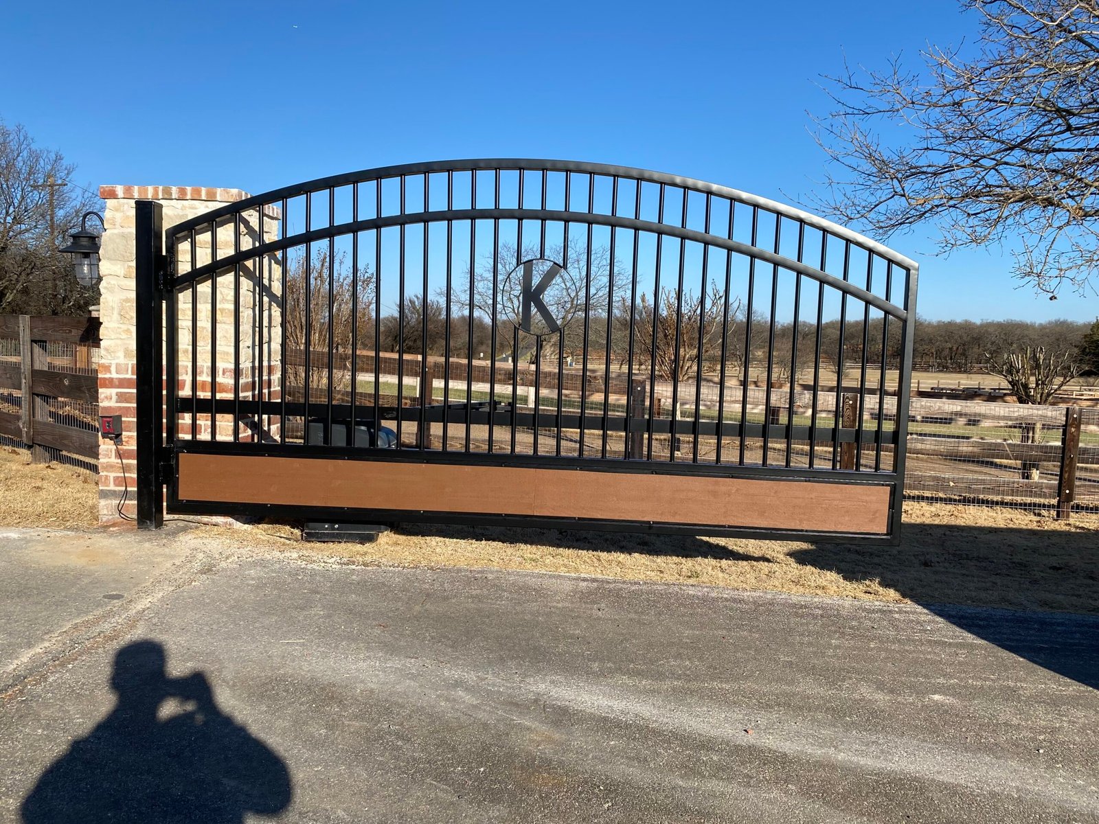 Original automatic swing gate with steel frame and wood lower panels