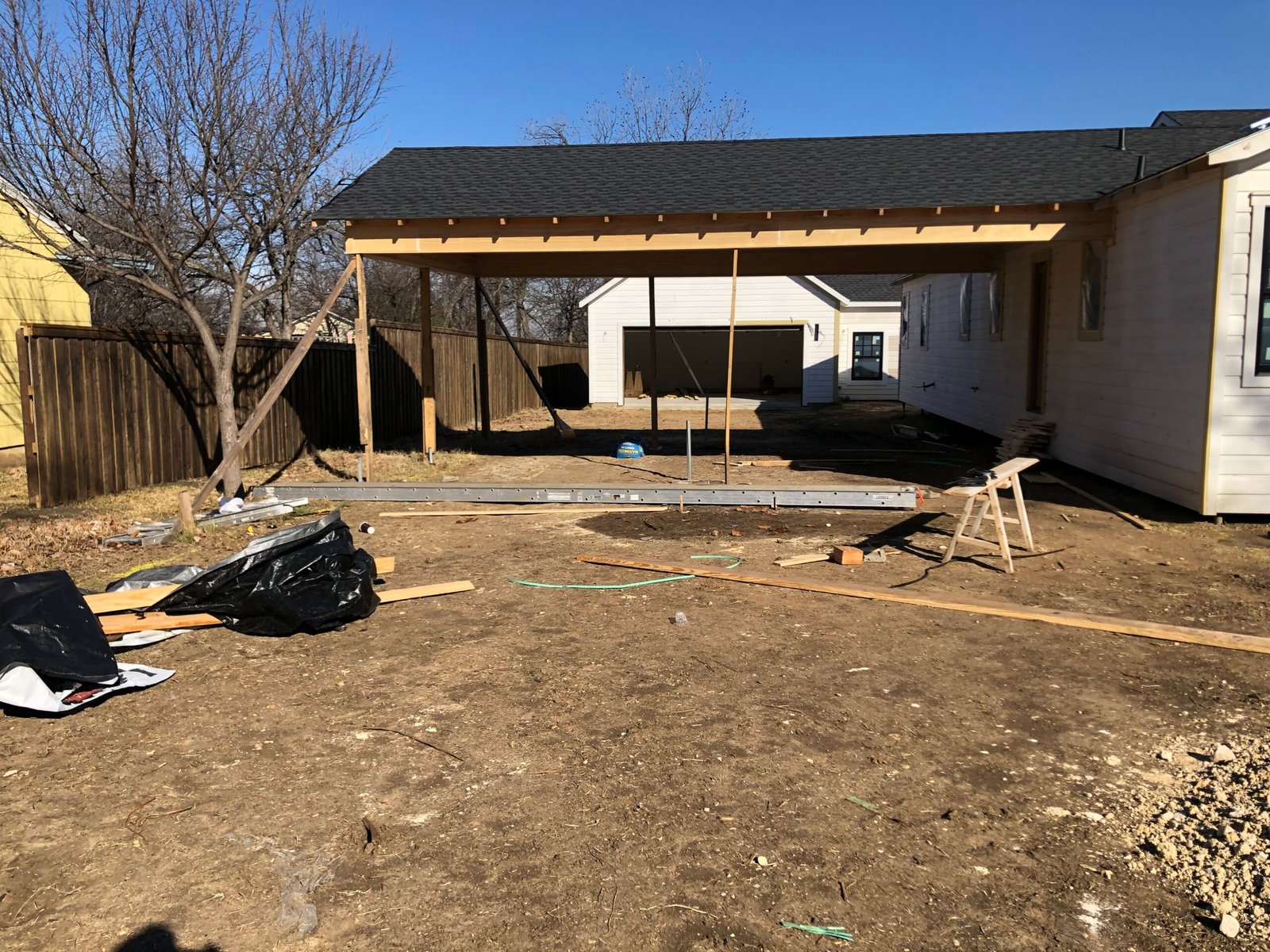 Custom driveway gate preparation during new home construction in North Texas