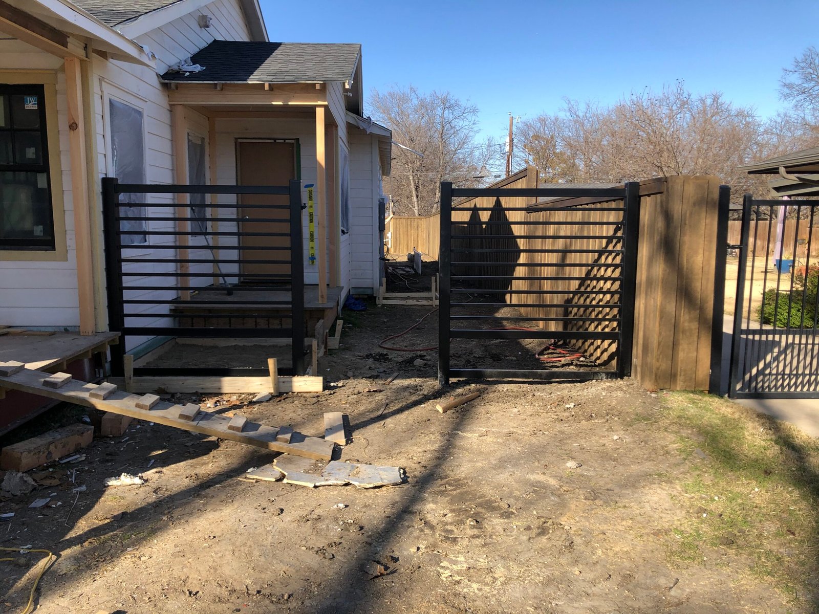 Covered custom gate during residential construction and concrete work