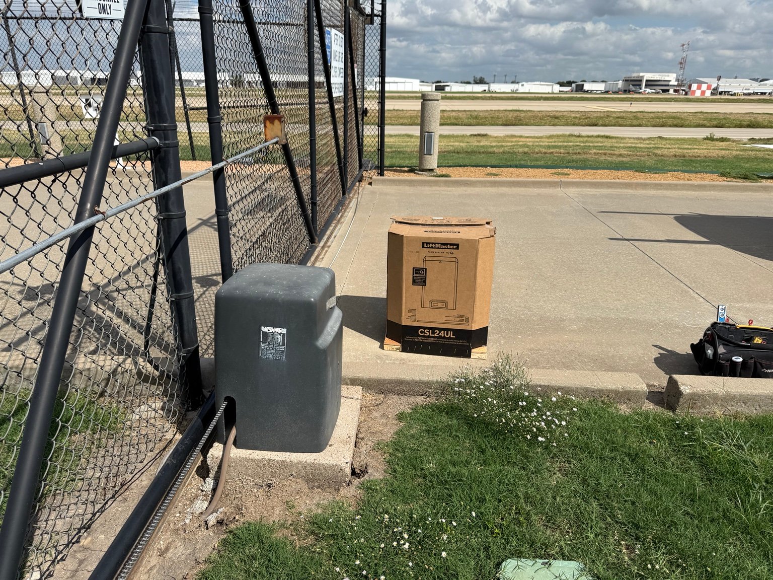 Old commercial sliding gate operator before replacement with LiftMaster CSL24UL at Dallas airport