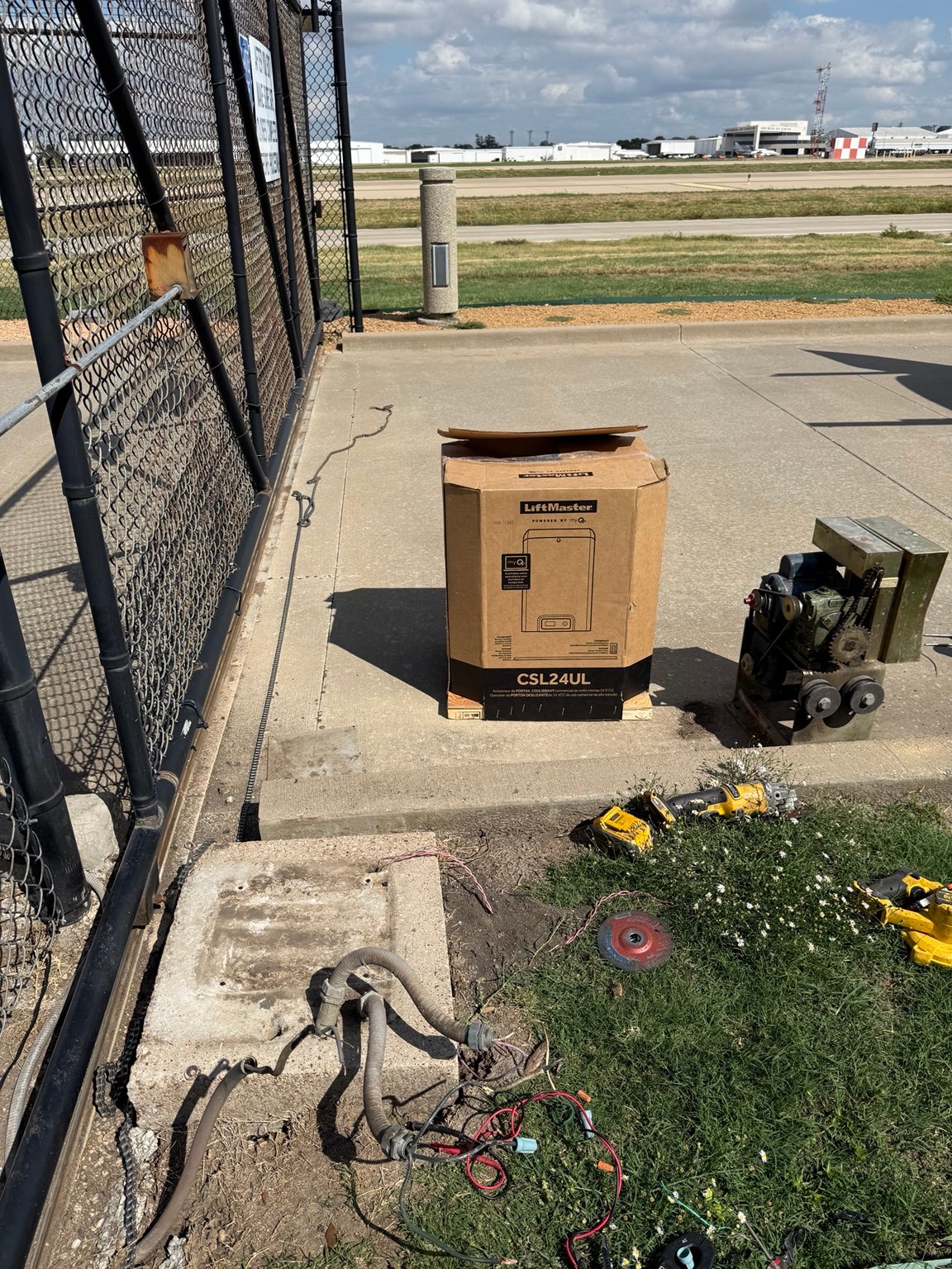 Old sliding gate operator removed during LiftMaster CSL24UL installation at Dallas Love Field Airport