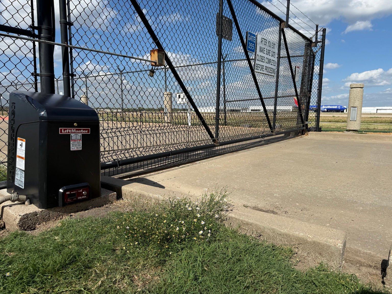 Completed LiftMaster CSL24UL runway access sliding gate installation at Dallas Love Field Airport