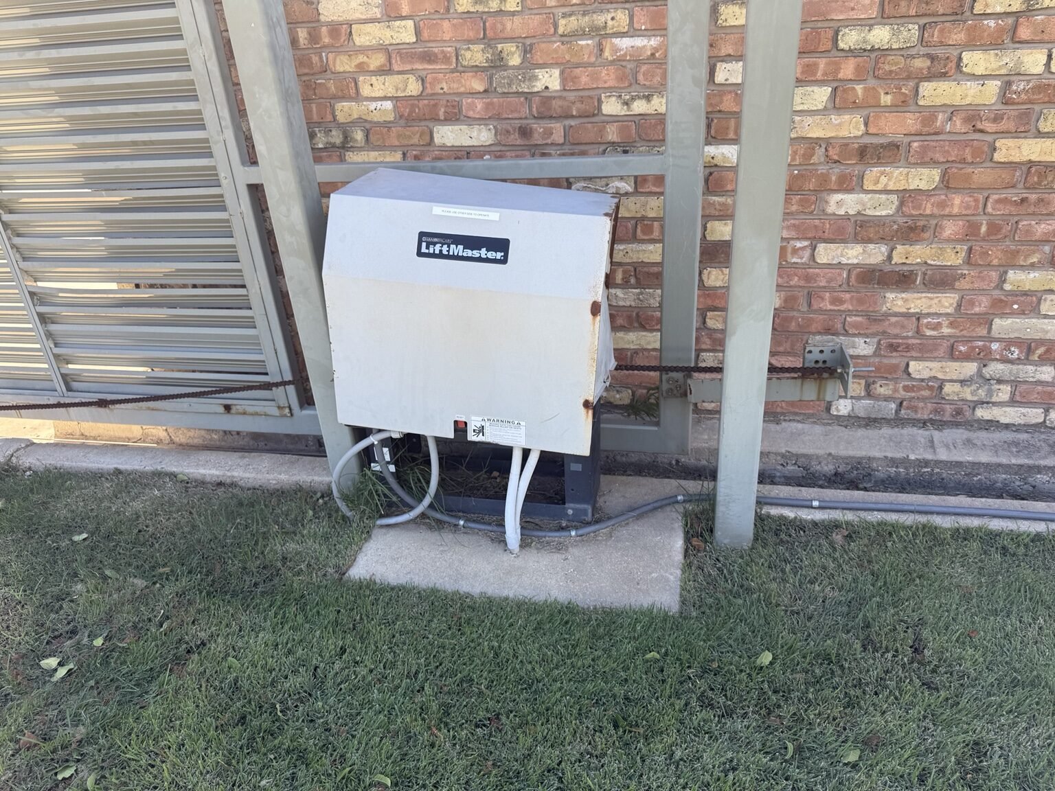 Discontinued LiftMaster commercial gate operator removed during Dallas replacement project